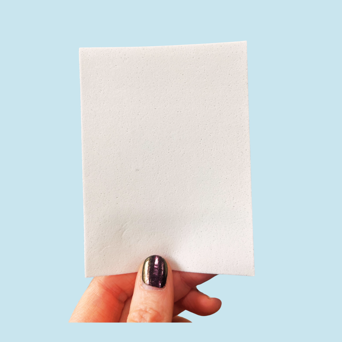 Hand holding a laundry detergent sheet - Laundry Detergent Sheet Fundraiser